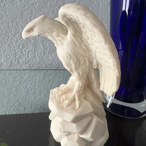 A vintage white carved alabaster eagle statue